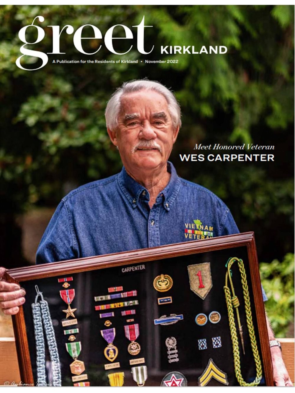 Honored veteran Wes Carpenter holding his shadow box of military medals